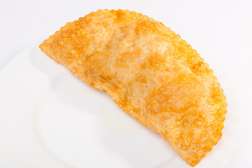 cheburek with lamb on white plate