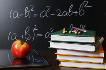 red apple on notebook with book stack