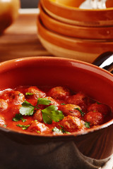 Meatball with tomato sauce in a pot, country style