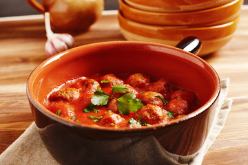 Meatball with tomato sauce in a pot, country style