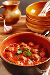 Meatball with tomato sauce in a pot, country style