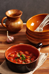 Meatball with tomato sauce in a pot, country style