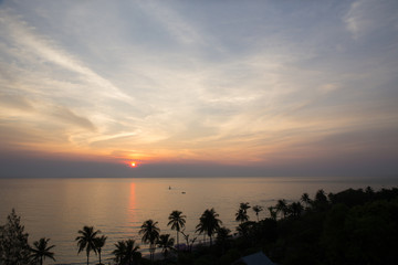 Fototapeta na wymiar sunrise and silhouette coconut tree at beach and sea