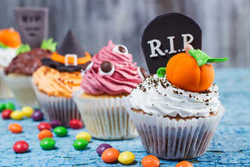 Halloween cupcakes with colored decorations