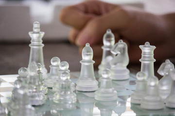 Transparent chess made fo glass on wood background , Focus sharp specific point