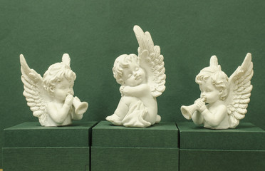 Three angels on a green background