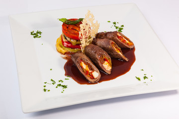 meat rolls with sauce and vegetables cheese