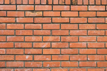 the old and dirty orange brick wall in warm or hot color tone/style with black stain for background texture