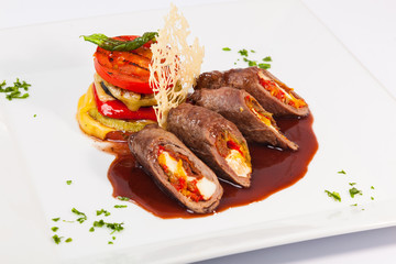 meat rolls with sauce and vegetables cheese