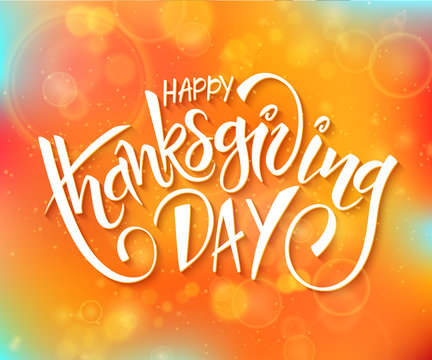 vector thanksgiving day greeting lettering phrase - happy thanksgiving day - on blur autumn background with flares