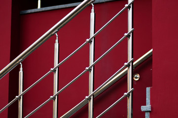 chrome ladder in front of red wall. 