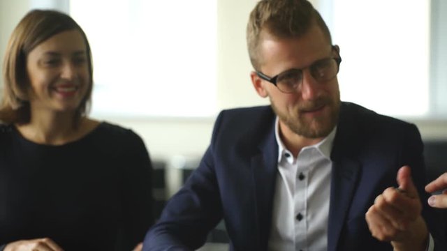 young couple is signing the sales contract and gets the key for the new car