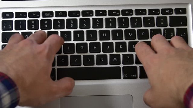 Young Man Writting An E-Mail Or Report On His Laptop, Hands Detail, Above Shot
