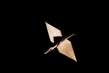 Cute origami art, colored shapes object isolated over a black background