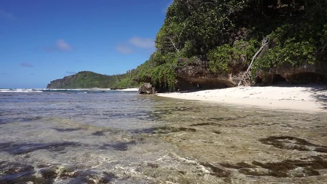 Coastal landscape with beach and cliff on the sea shore of Rurutu island, south Pacific ocean, Austral archipelago, French Polynesia
