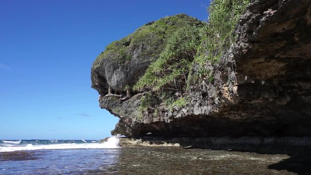 Eroded rocky shore with natural formation that looks like a monster head, Rurutu island, Pacific ocean, Austral archipelago, French Polynesia
