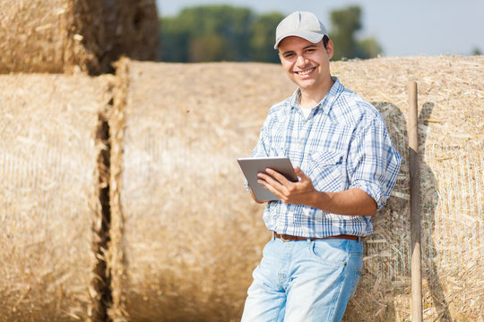 Smiling Farmer Using A Tablet