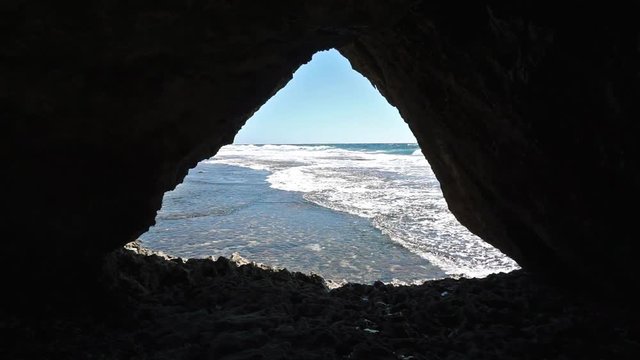Sea shore seen from a small cave in the rocks, Rurutu island, Pacific ocean, Austral archipelago, French Polynesia
