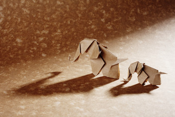 Cute origamis art, colored animals shapes isolated over a wooden background