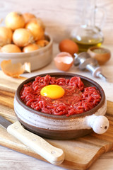 Raw minced meat, eggs, olive oil and onions