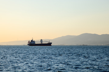 Sunset to the sea North. Ships container ships relating to the sky with the skyline.