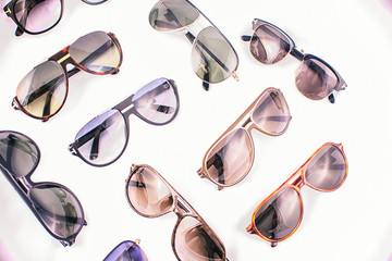 Assorted sunglasses over white background