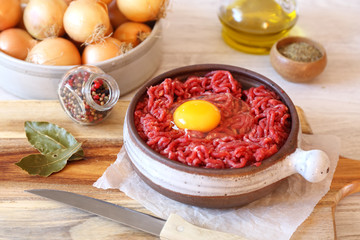 Raw minced meat with egg, olive oil, spices and onions