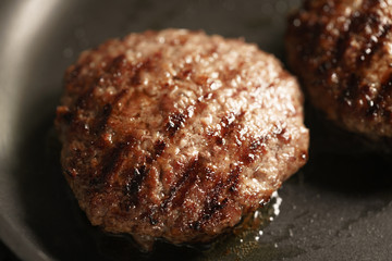 beef cutlets rest on frying pan