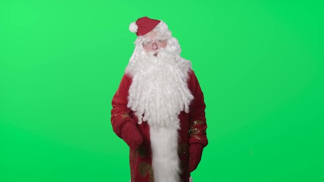 Ded Moroz (Santa Claus, Pere Noel) congratulates you with New year and Christmas. The hat falls from the head. Green screen, chromakey