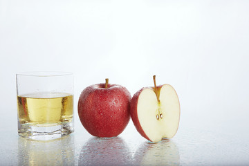 apples and apple juice on white background