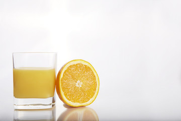 half orange with orange juice on white background 1