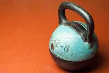 Plakat Old weight on a red background