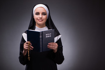 Religious nun in religion concept against dark background