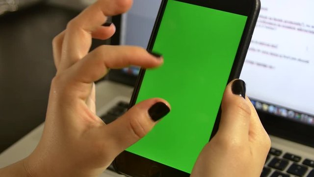 Young Woman Trying To Enlarge A Picture Or An Article On Her Smart Phone
 Green Screen