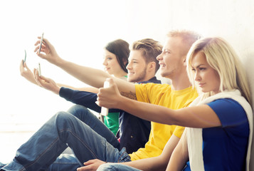 Group of hipsters taking a selfie in the school