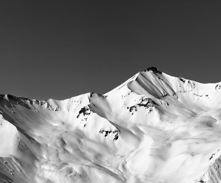 Fototapeta Black and white off-piste snowy slope in winter mountain