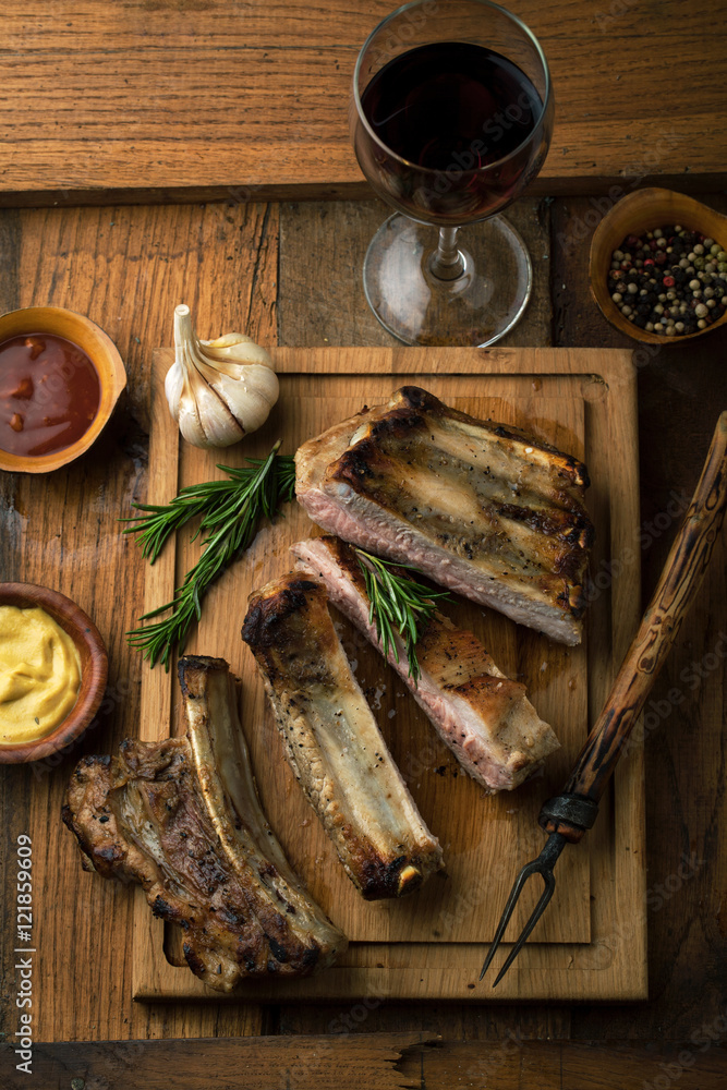 Sticker Pork ribs grilled with rosemary and a glass of wine