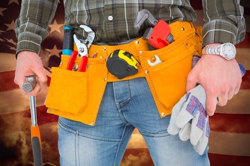 Composite image of manual worker holding gloves and hammer