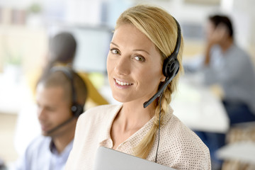 Closeup of customer service manager standing in call center