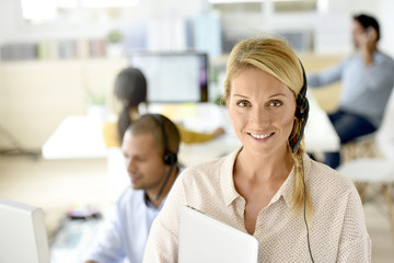 Closeup of customer service manager standing in call center