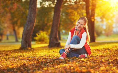 happy young woman resting outdoors in autumn