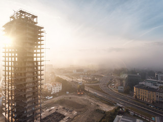 Large unfinished building at sunset time with fog near Krakow city center, Unity Tower