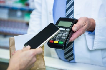 Customer making payment through smartphone in payment terminal