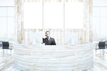 Man at reception talking on phone