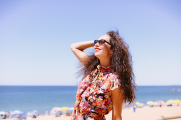 Beautiful elegant female on sandy beach blue sky background