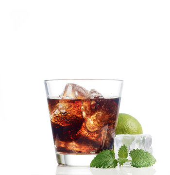 cola with ice and lime on white background