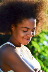 laughing young happy and  pretty afro wooman on natural background