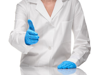 Doctor in gown giving hand in blue glove for handshake