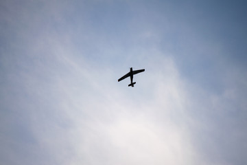 Zlin Z-526F acrobatic airplane flying on cloudy sky