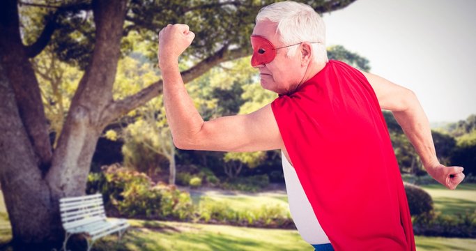 Composite image of senior man pretending to be a superhero
